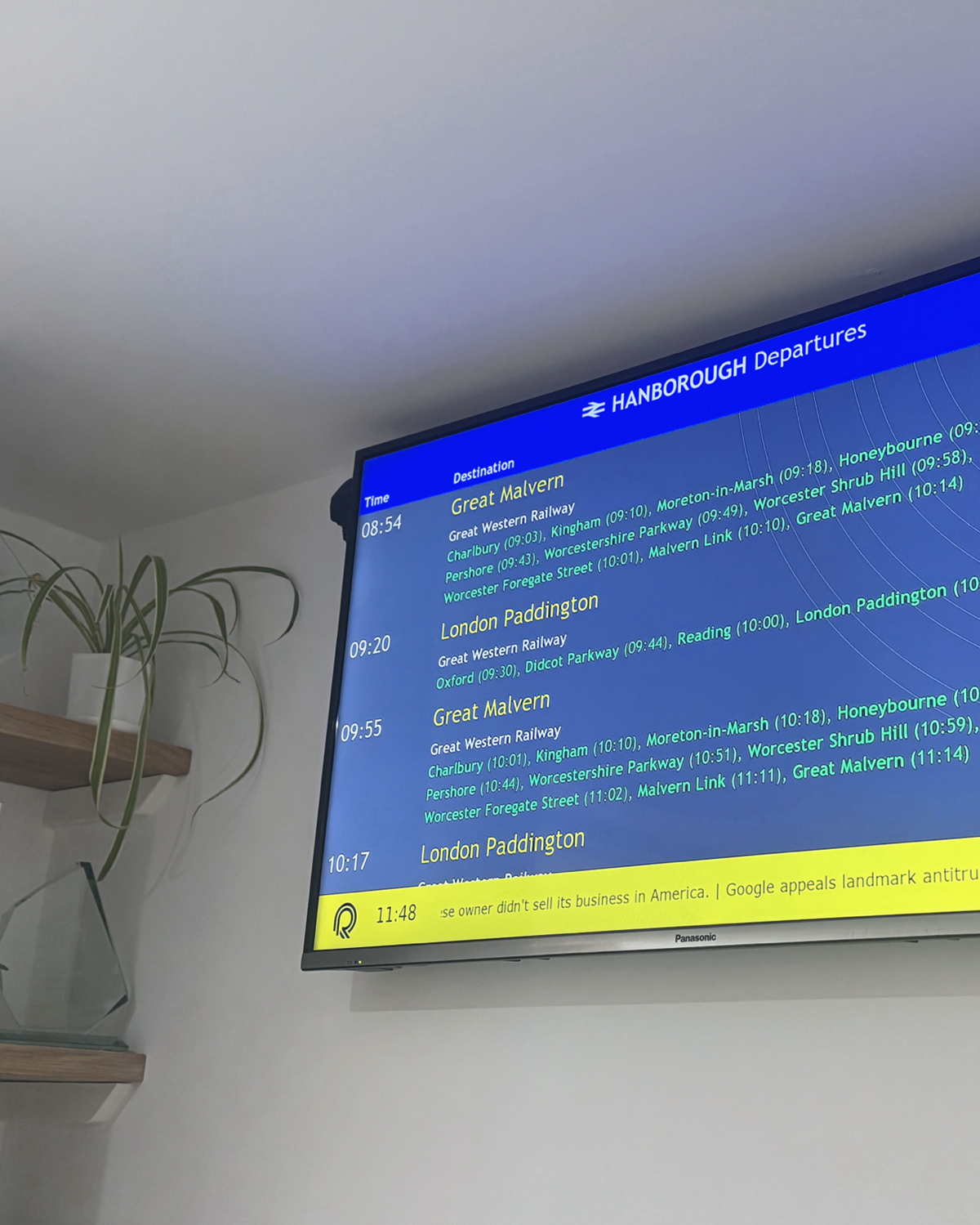 A digital info screen displaying train departure times from Hanborough Station